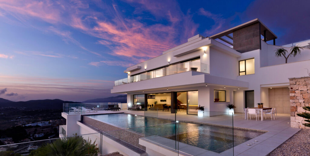 image of a house in the sunset light with a swimming pool at its feet